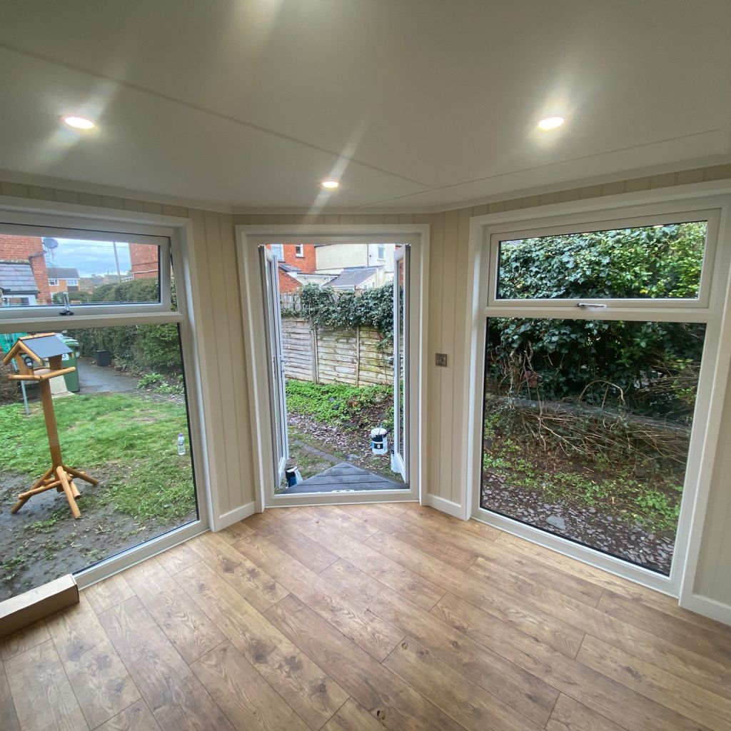 corner garden room with french doors and large glass windows 