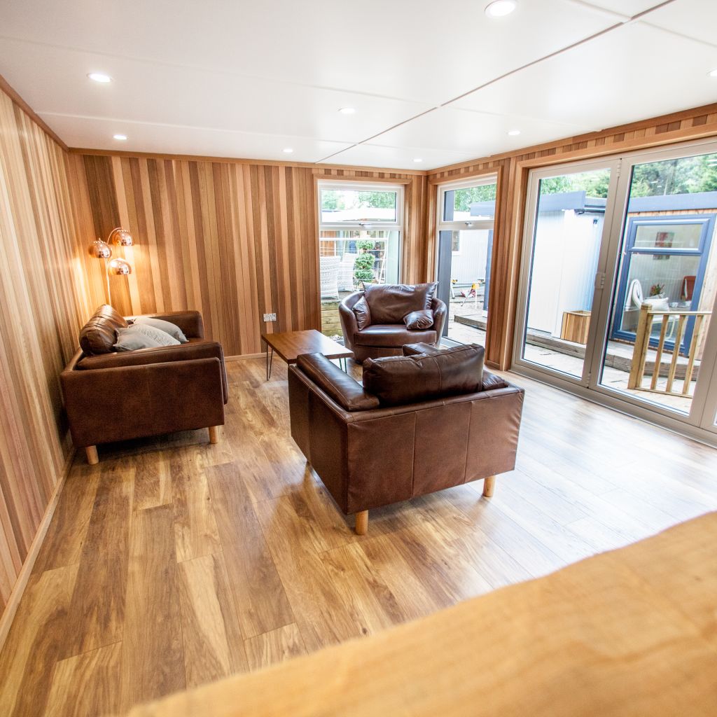 brown leather armchairs and copper lamps inside show site entertainments room