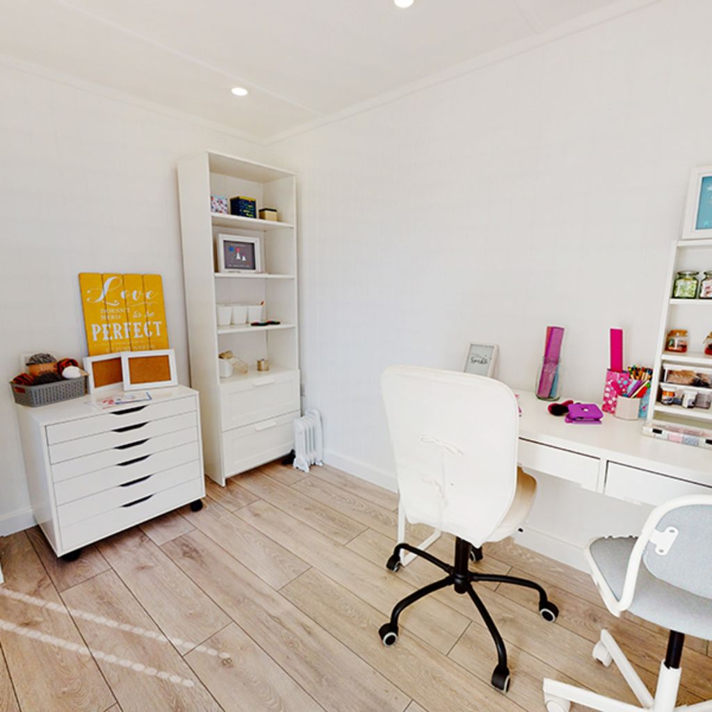 small white desk with swivel chair and hobby and craft accessories