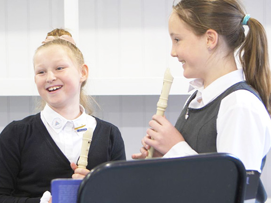 Langar pupils practising music in their music cabin