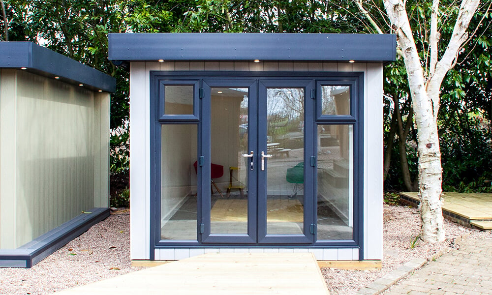 Small zero maintenance garden room in light grey at the Nottingham show site
