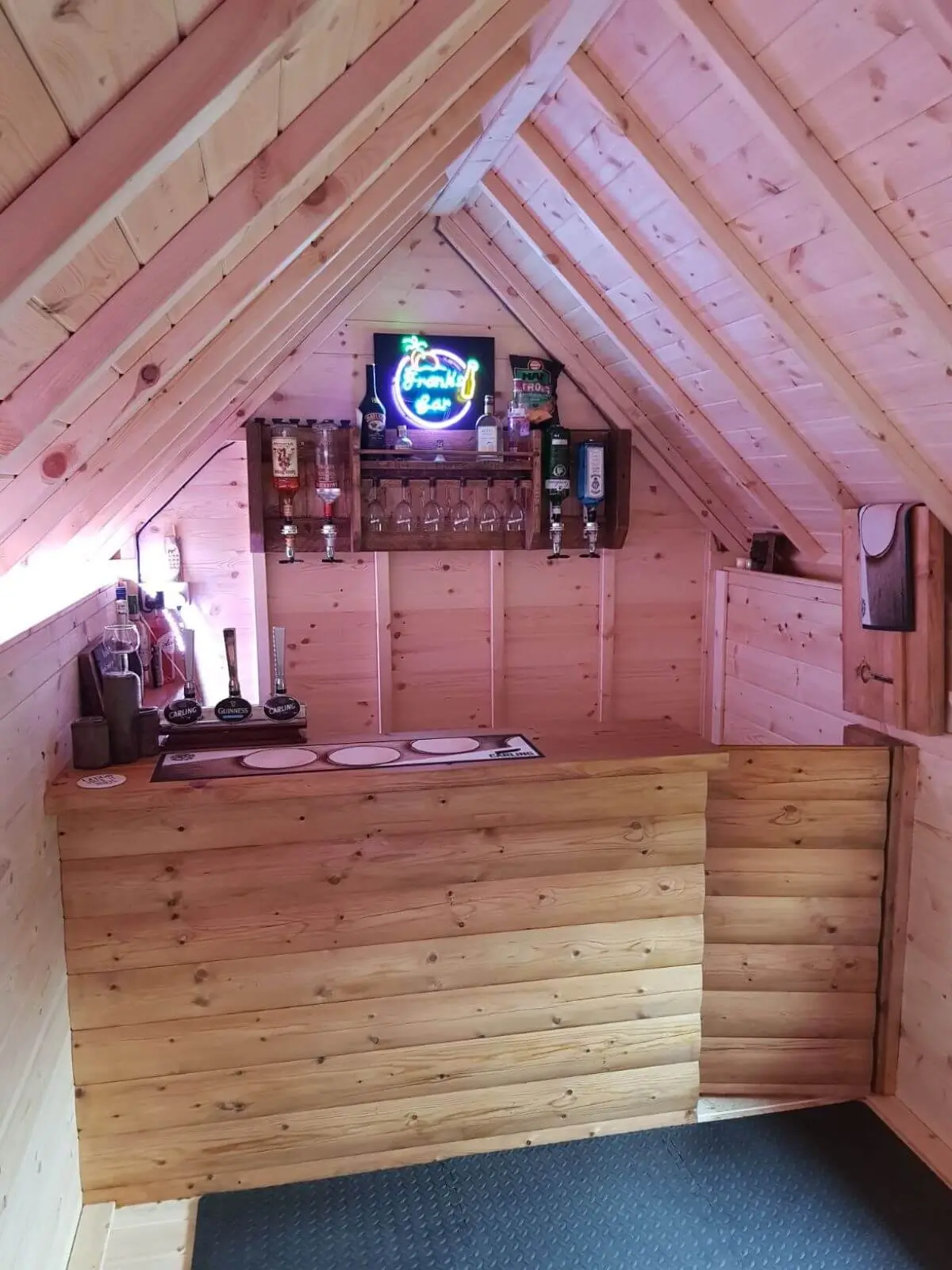 inside of camping cabins building with bar extension and drinks rack and draft ales and beer mat